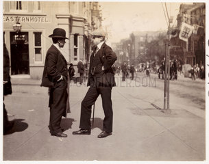 Two smartly dressed men in conversation  c 1900.