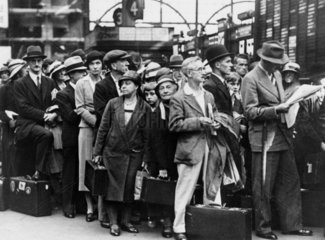 Passengers waiting at Waterloo station  London  1930s.