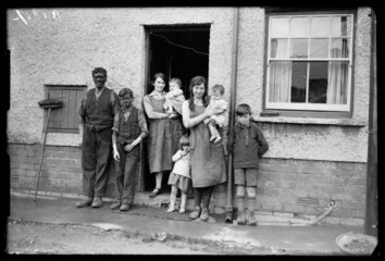 A miner and his family outside their home  North Wales  1931.