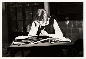 Schoolgirl doing her homework  c 1935.