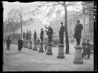 Men standing on bollards to watch a demonstration  1934.