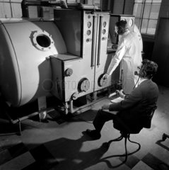 Exterior of high alititude chamber with controls and technicians  1965.