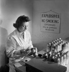 A female worker loads bomb fuses  Leeds  1953.