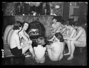Nudists gathered at the fireside  1938.