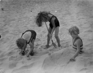 Children digging in the sand  1935.