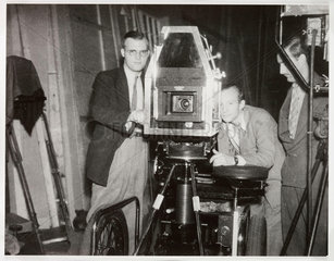 Crew operating a film camera on set  c 1940s.