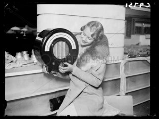 Woman holding an Ekco radio  Radiolympia  London  1934.