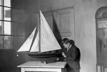 Young boy inspecting a toy yacht  Selfridge