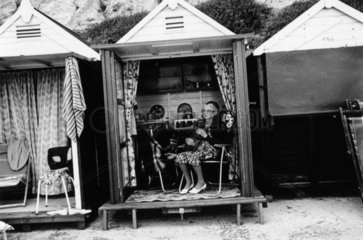 Elderly woman seated in a beach hut  1968.
