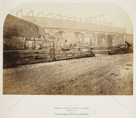 Temporary wooden railway bridge over Old St Pancras Road  London  c 1867.