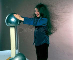 Girl holding a Van de Graaff generator  1998.