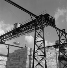 Mill worker with crane  gantry and pulp paper stocks  Blackburn 1959.