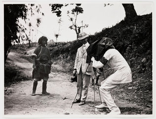 Europeans photographing an Asian man  c 1925.