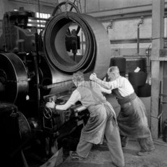 Two men operate brake lining production machine at Ferodo  1954.