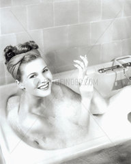 Woman taking a bath  1950s.