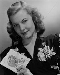 Portrait of a woman holding Valentine's card  1949