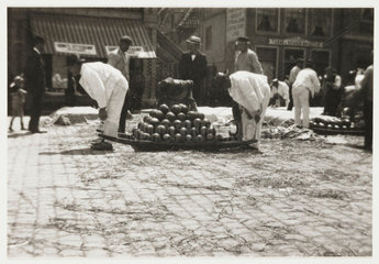 Men carrying cheese  c 1905