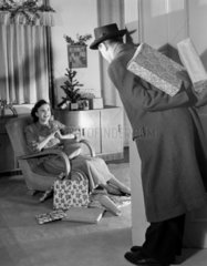 Man bringing Christmas presents  c 1949.