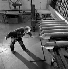 A worker tests a row of finished liquid oxygen bottles  British Oxygen  1964.
