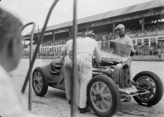 Mechanics work on Louis Chiron’s Bugatti  Nurburgring  Germany  1932.