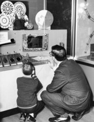 Visitors looking at an exhibit  Science Museum  London  1948.