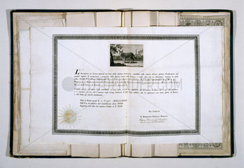 Open folio of diplomas awarded to Charles Babbage  19th century.
