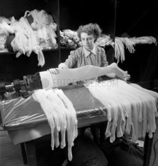 A female worker Inspects woolen tights at the Aristoc mill  1952.