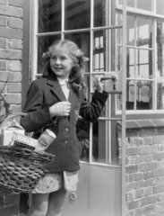 Girl carrying a shopping basket  1949.