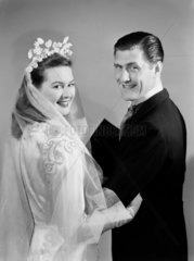 Smiling bride and groom  c 1949.