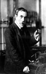 Sir William Ramsay holding a pocket spectrometer  c 1900.