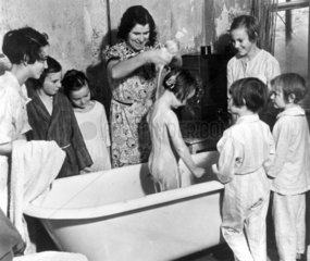 Young girl being washed in a bathtub  1 Nov