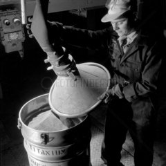 Man removing lid of titanium hopper after filling  ICI WIlton  1955.