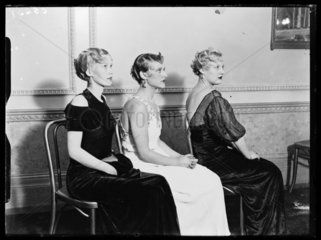 Three models displaying the latest in women's hairdressing fashions  1933.
