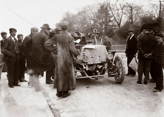 Crowd of men around a motor car during the 1000 Mile Trial  1900.