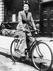 Young woman on a bicycle  wearing a trouser