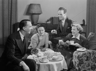 Two couples having tea and cake  1949.