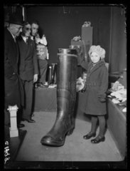 Young girl and a giant Wellington boot  1933.