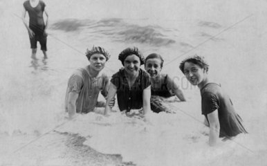 Family bathing in the sea  early 20th century.
