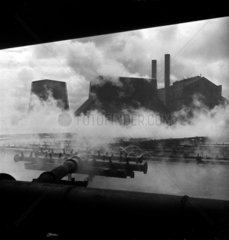 Steam rises from steel plant cooling towers  Workington  1952.