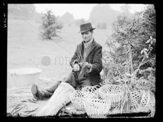 Romany man weaving wicker baskets on Epsom Downs  Surrey  18 May 1939.