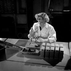 Female worker assembles cine camera  1956.