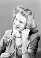 Woman answering the telephone  1950.