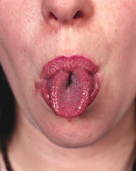 Woman rolling her tongue.