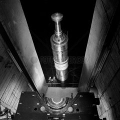 A giant rotor us lowered into a high speed balancing pit   Parsons  1962.