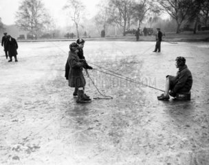 Children playing on a frozen pond  Wimbledon  London  27 January 1932.