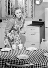 Woman setting the kitchen table  1952.