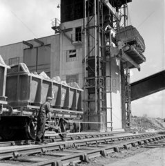Loaded rail wagons of granite are lifted and tipped in to silo  1948.