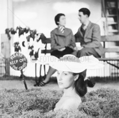 Woman wearing flower hat  1950s.