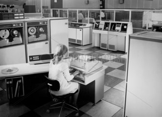 A female programmer at console inputs English Electric computer  1967.