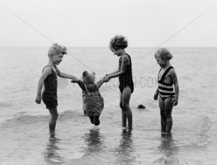 Children playing in the sea  1933.